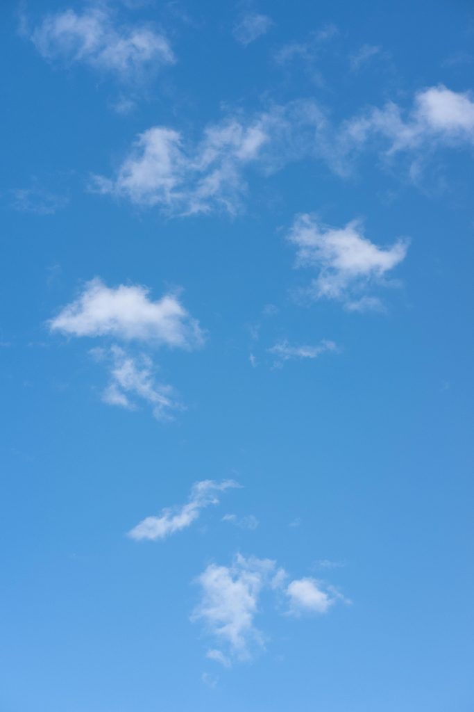 pexels photo 7744252 7744252 A clear blue sky scattered with fluffy clouds in daylight, perfect for backgrounds.